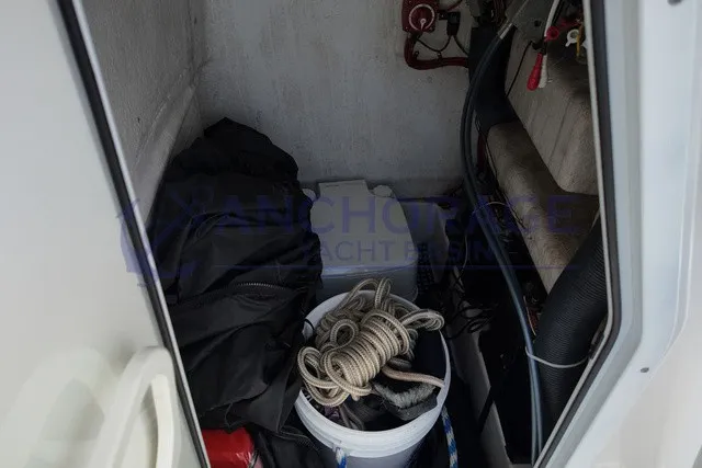 Slide: The Image of A storage area with ropes, a bucket, and equipment on a Sportsman Heritage 211 Center Console boat. - 7