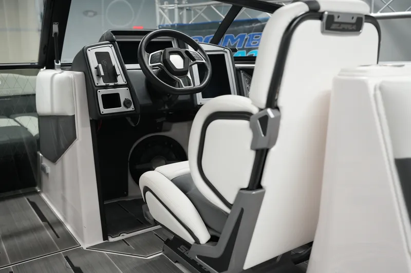Slide: The Image of Interior of 2023 Supra SA 450 boat, featuring modern steering and sleek white seating. - 17