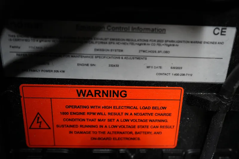 Slide: The Image of Warning label on 2023 Supra SA 450 engine, highlighting electrical load and RPM caution. - 23