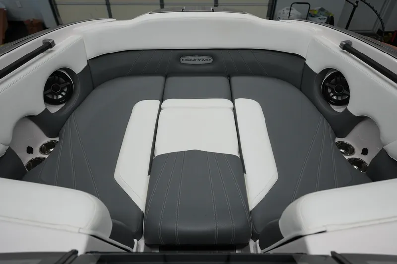 Slide: The Image of 2023 Supra SA 450 boat interior with gray and white seating and built-in speakers. - 18