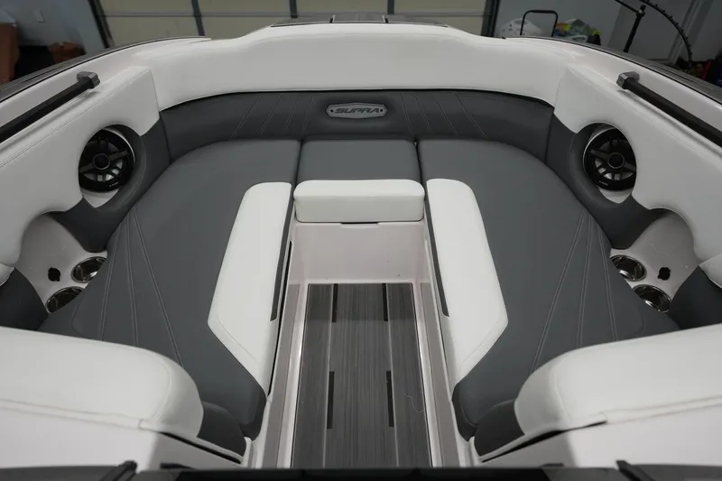 Slide: The Image of 2023 Supra SA 450 boat interior with gray and white seating, featuring built-in speakers. - 20