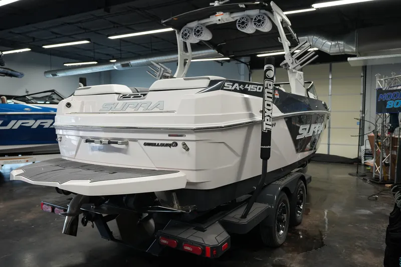 Slide: The Image of 2023 Supra SA 450 boat in showroom, featuring sleek design and advanced wakeboarding features. - 5
