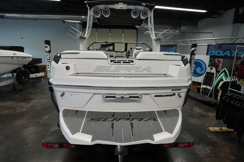 Slide: The Image of 2023 Supra SA 450 boat rear view in showroom, featuring sleek design and advanced audio system. - 4