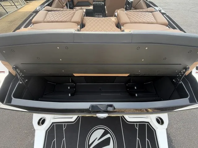 Slide: The Image of The image shows the storage area of a 2027 Tigé Z1 boat with cushioned seating. - 24