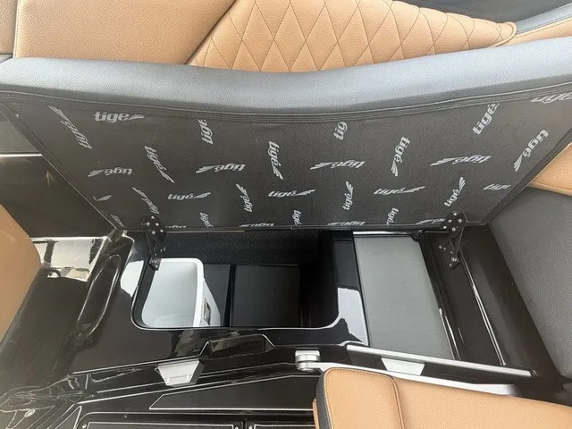 Slide: The Image of The image shows storage space under a seat in a 2027 Tigé Z1 boat. - 17
