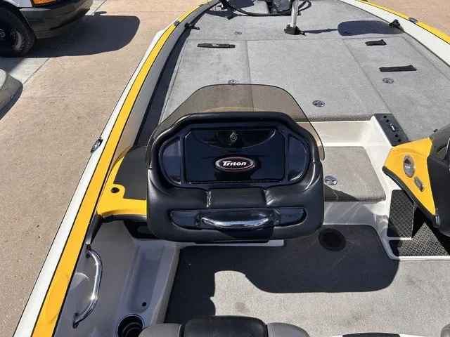 Slide: The Image of The image shows the cockpit of a 2015 Triton 20 TrX boat with gray and black interior. - 15