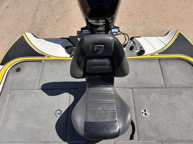 Slide: The Image of A black seat on a gray boat deck, with an engine in the background. - 21
