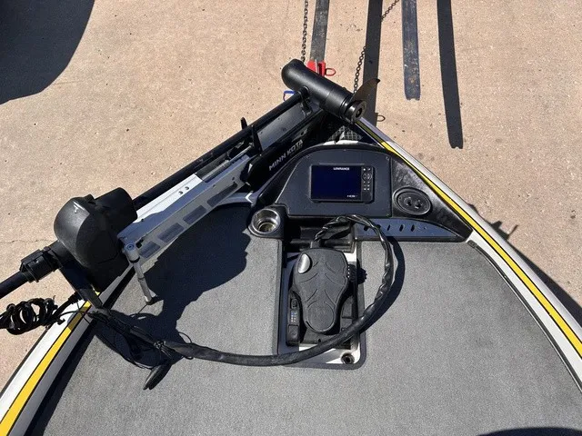 Slide: The Image of The image shows the bow deck of a 2015 Triton 20 TrX with a fish finder and trolling motor. - 16