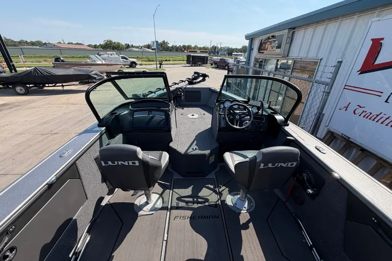 Slide: The Image of 2024 Lund 1875 Fisherman boat interior with dual seats and steering console. - 12