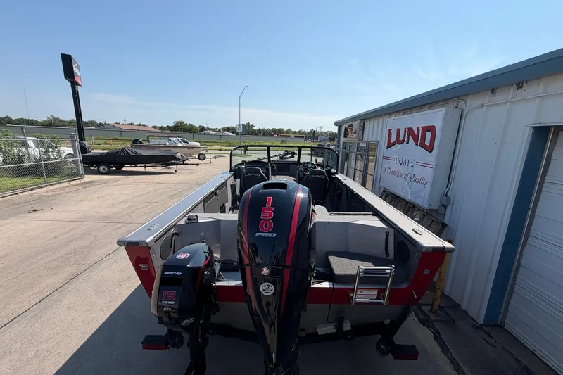 Slide: The Image of 2024 Lund 1875 Fisherman boat with dual Mercury engines at dealership. - 2