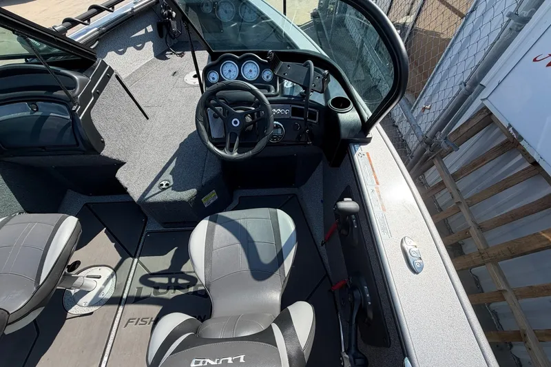 Slide: The Image of 2024 Lund 1875 Fisherman boat interior with steering wheel and seating. - 13