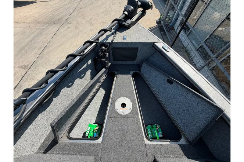 Slide: The Image of 2024 Lund 1875 Fisherman boat interior with storage compartments and fishing gear. - 15
