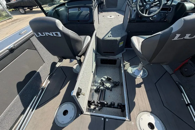 Slide: The Image of 2024 Lund 1875 Fisherman boat interior with storage compartment and seating. - 17