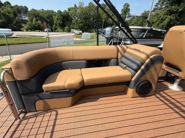 Slide: The Image of The image shows a luxurious seating area on a pontoon boat with brown and gray upholstery. - 4