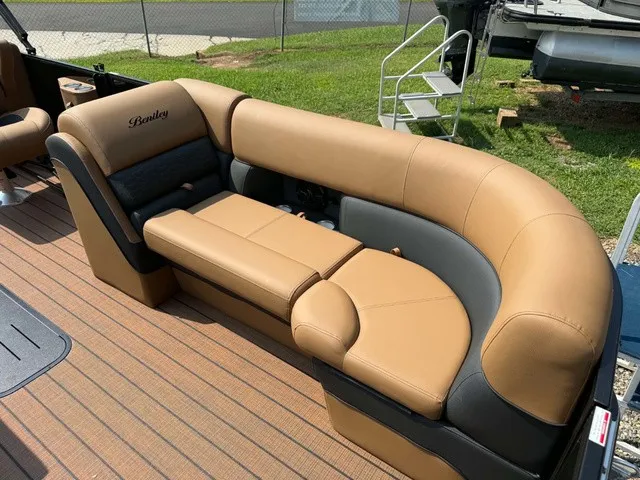 Slide: The Image of The image shows a luxurious, cushioned seating area on a pontoon boat with brown and black leather. - 10