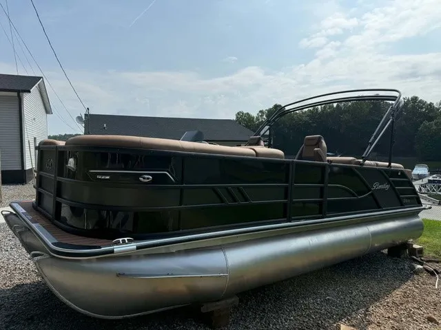 Slide: The Image of Bentley Pontoons Elite 223 Admiral 2027 on a gravel lot, featuring sleek seating and modern design. - 2