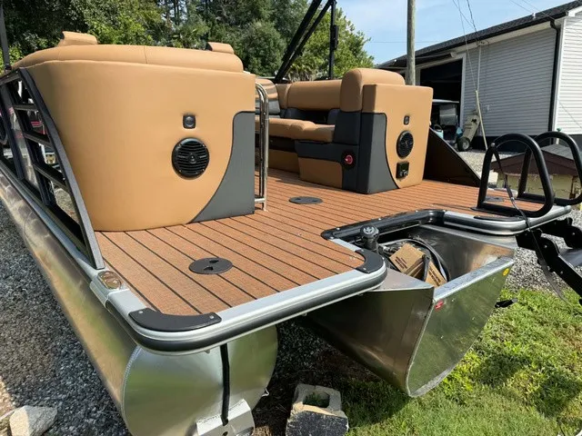 Slide: The Image of The image shows the rear of a 2027 Bentley Pontoons Elite 223 Admiral with sleek seating and wood flooring. - 5