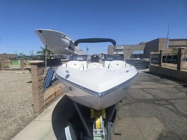 Slide: The Image of A white boat on a trailer in a showroom setting. - 29