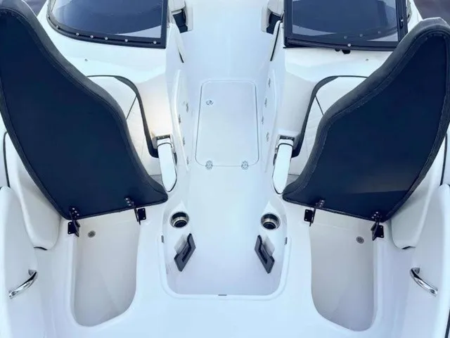 Slide: The Image of The image shows the cockpit of a Stingray 23 OSX boat with two black seats. - 8