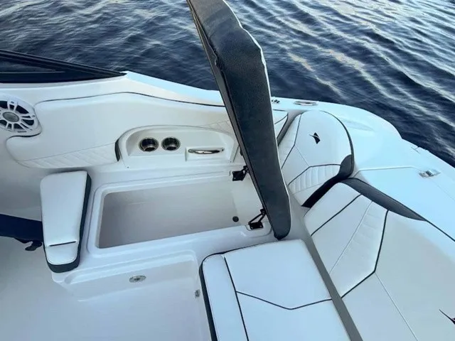 Slide: The Image of The image shows the cockpit of a 2027 Stingray 23 OSX boat with white upholstery and black accents. - 20