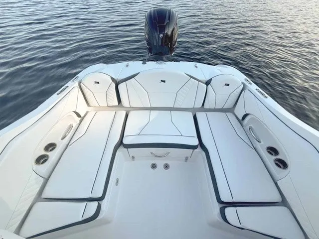 Slide: The Image of The image shows the stern of a 2027 Stingray 23 OSX boat with sleek seating. - 21