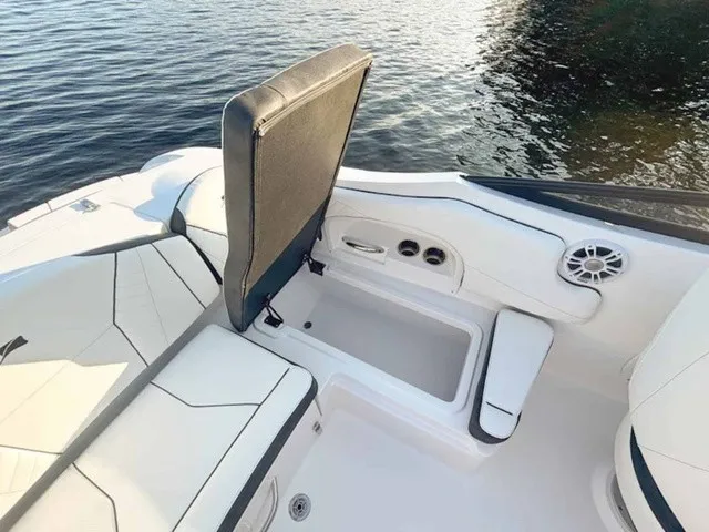 Slide: The Image of The image shows the cockpit of a Stingray 23 OSX boat with white upholstery and speakers. - 19