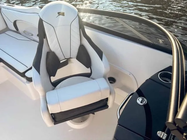Slide: The Image of A sleek white and black captain's chair on a modern boat, surrounded by water. - 17