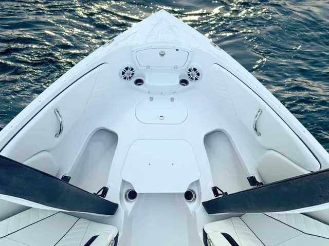 Slide: The Image of The image shows the bow of a white boat on calm water. - 7