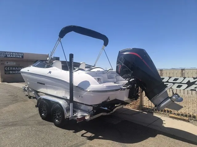 Slide: The Image of Stingray 23 OSX 2027 on a trailer with an outboard motor. - 27