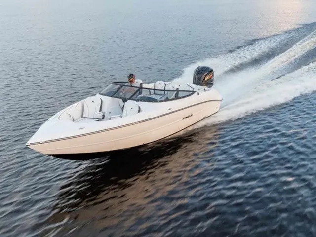 Slide: The Image of A white motorboat speeding across calm water. It features an open cockpit and an outboard engine. - 1