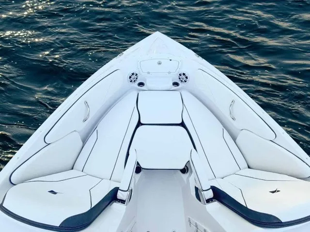 Slide: The Image of The 2027 Stingray 23 OSX features a sleek, white bow design with cushioned seating. - 5