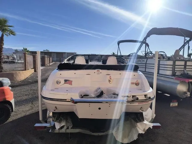 Slide: The Image of The image shows a 2027 Stingray 23 OSX boat parked in a lot. - 31