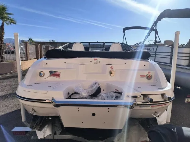 Slide: The Image of The image shows the rear of a 2027 Stingray 23 OSX boat with dual engines. - 35