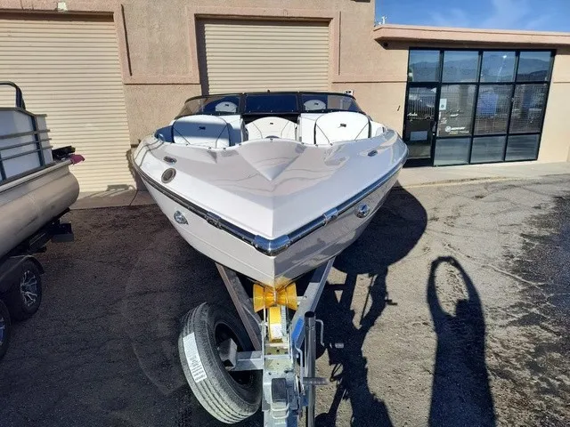 Slide: The Image of A modern 2027 Stingray 23 OSX on a trailer in front of a building. - 33