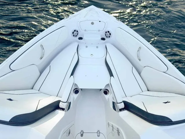 Slide: The Image of The image shows the bow of a Stingray 23 OSX boat with white upholstery. - 6