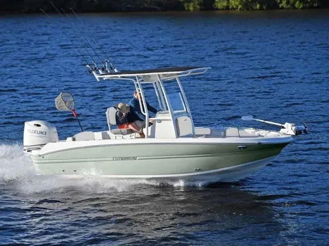 Slide: The Image of A modern 2027 Stingray 20 CC speeds across the water. It features a T-top and fishing rods. - 14