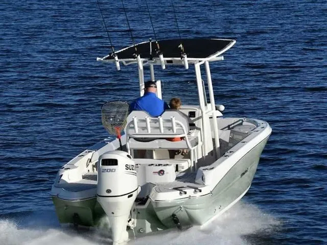 Slide: The Image of 2027 Stingray 20 CC on the water with Suzuki outboard motor and fishing rods. - 11