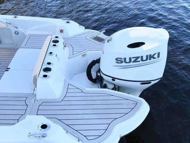 Slide: The Image of The image shows the stern of a 2027 Stingray 20 CC boat with a Suzuki outboard motor. - 17
