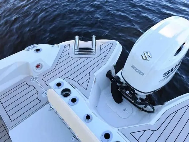 Slide: The Image of The image shows the stern of a 2027 Stingray 20 CC boat with a Suzuki outboard motor. - 6