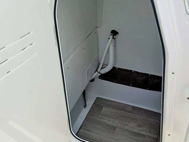 Slide: The Image of Interior of a boat with wooden flooring and piping along the wall. - 12