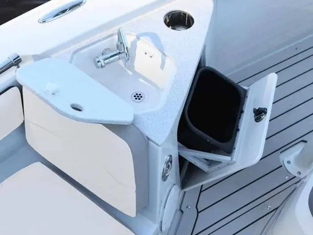 Slide: The Image of The image shows a compact sink with a faucet and storage space on a boat. - 18