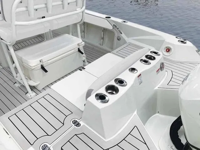 Slide: The Image of The image shows the deck of a 2027 Stingray 20 CC boat with seating and cup holders. - 15