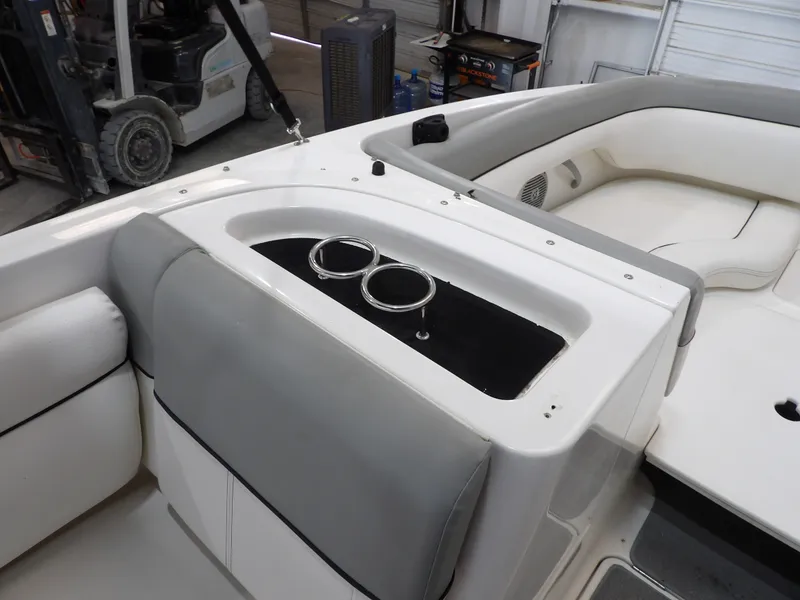 Slide: The Image of The image shows the cockpit of a 2013 Bayliner 190 Deck Boat with cup holders. - 14