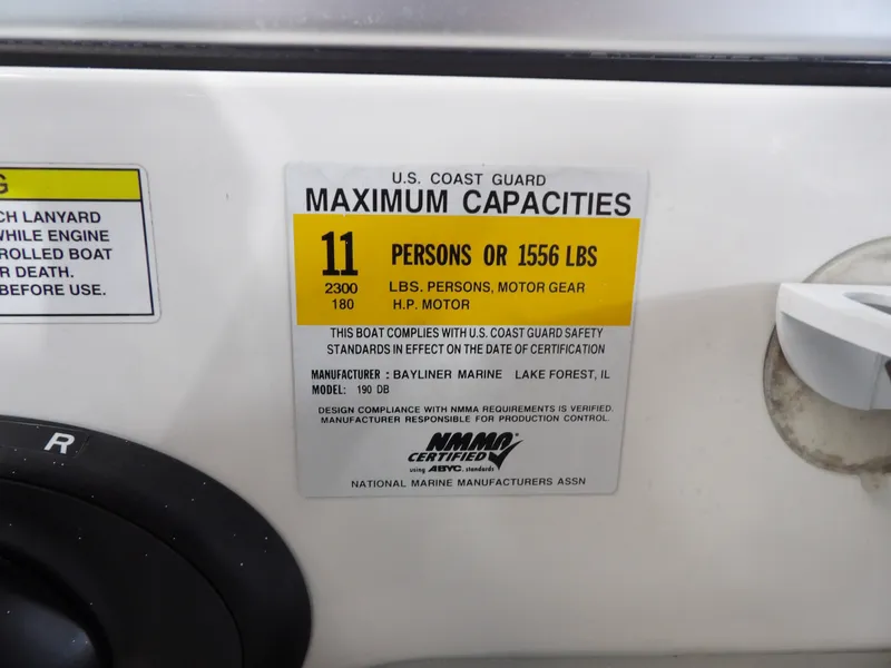 Slide: The Image of A label on a 2013 Bayliner 190 Deck Boat shows maximum capacities: 11 persons or 1556 pounds. - 25
