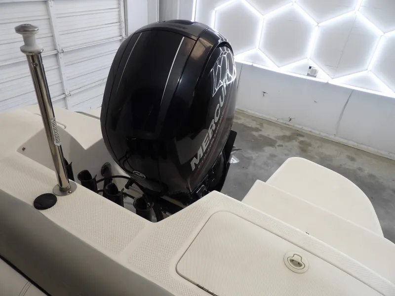 Slide: The Image of A Mercury outboard motor on a 2013 Bayliner 190 Deck Boat in a garage. - 24