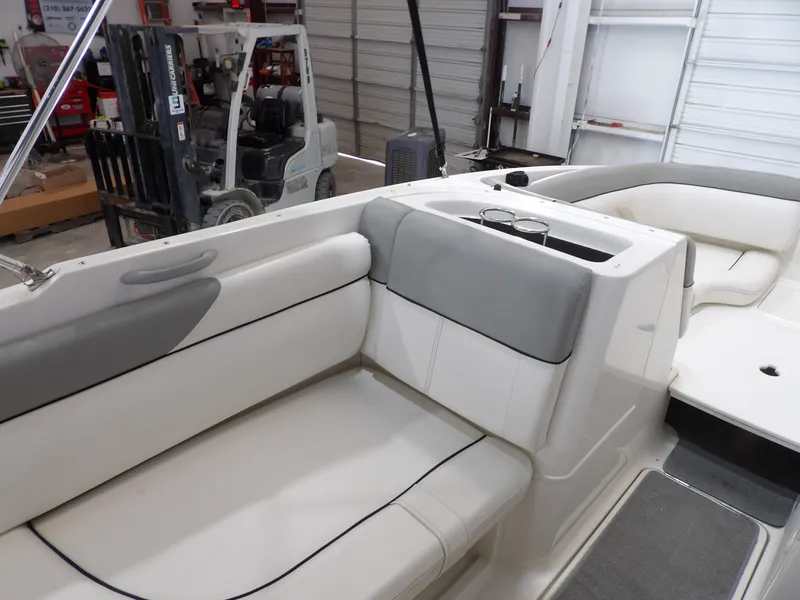 Slide: The Image of The image shows the interior of a 2013 Bayliner 190 Deck Boat with gray and white seating. - 16