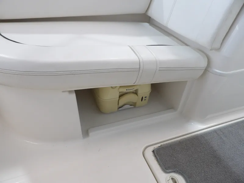Slide: The Image of A white seat with storage underneath, containing a portable toilet. - 27