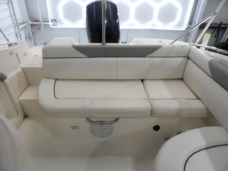 Slide: The Image of The image shows the white seating area of a 2013 Bayliner 190 Deck Boat. - 21
