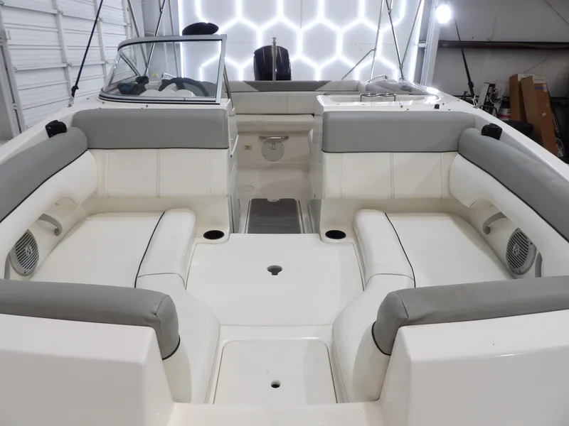 Slide: The Image of The image shows the spacious cockpit of a 2013 Bayliner 190 Deck Boat with gray upholstery. - 12