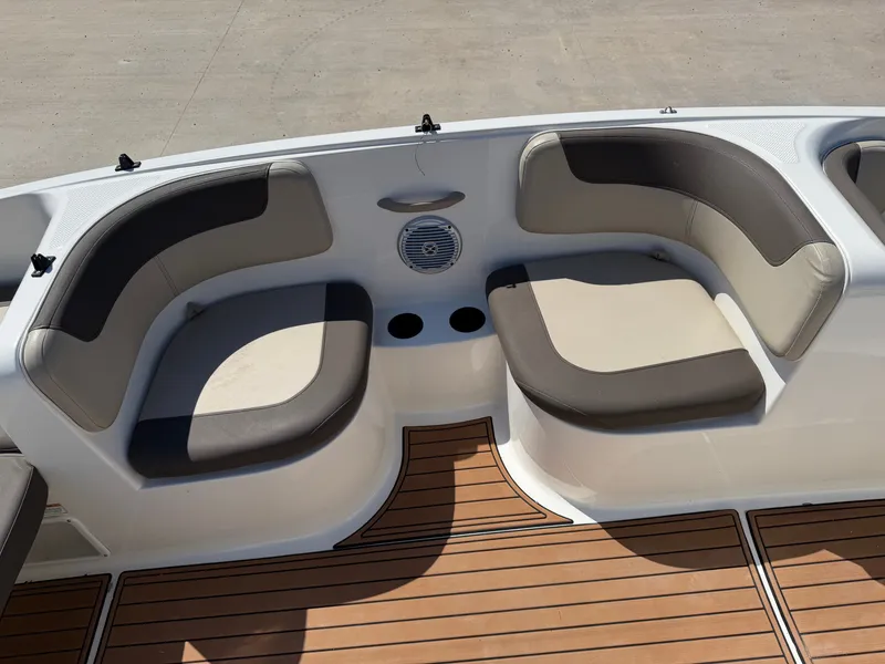 Slide: The Image of The image shows the seating area of a 2017 Bayliner Element 16 with brown and gray cushions. - 16